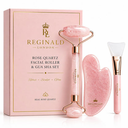 Rose Quartz Ritual Set by Reginald London — gua sha, dual-headed facial roller and silicone applicator brush, presented in a pink magnetic gift box with a how-to-use guide printed inside the lid.